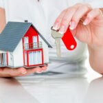 real estate agent with house and key