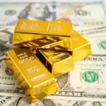 linkuma-gold-bar-on-us-dollar-banknotes-money-and-