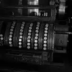 a black and white photo of an old typewriter